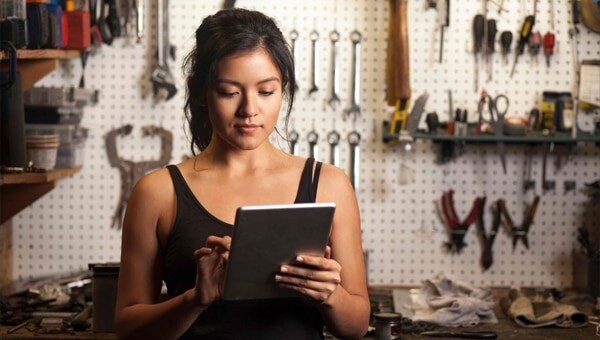 Woman in front of tool display with tablet