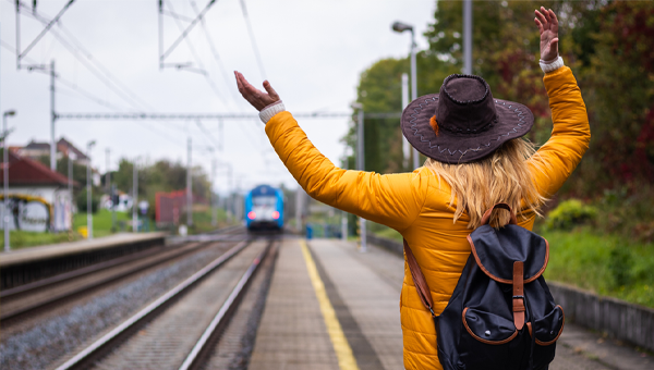 Woman waving at a train
