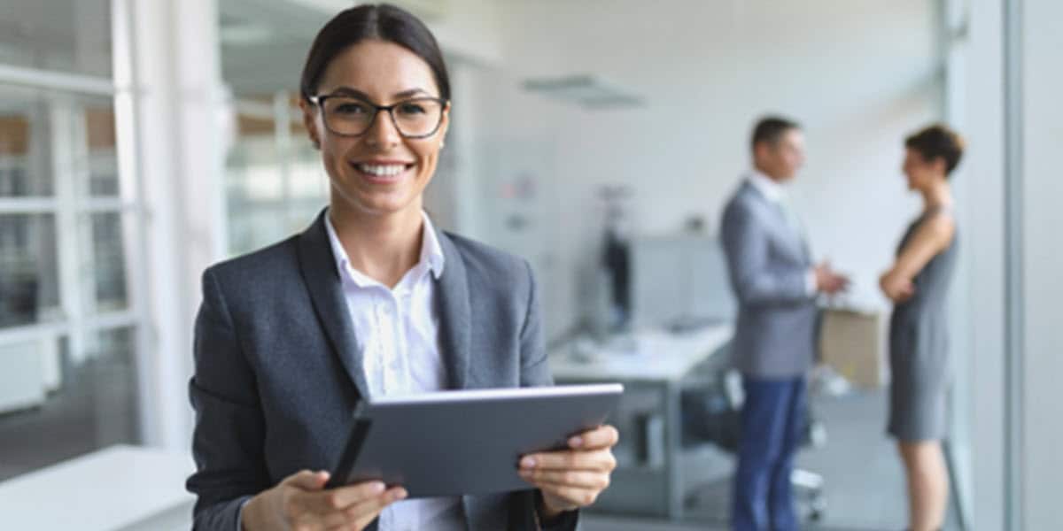 woman holding tablet standing in office