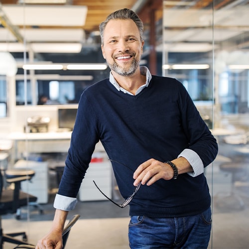 man leaning on desk
