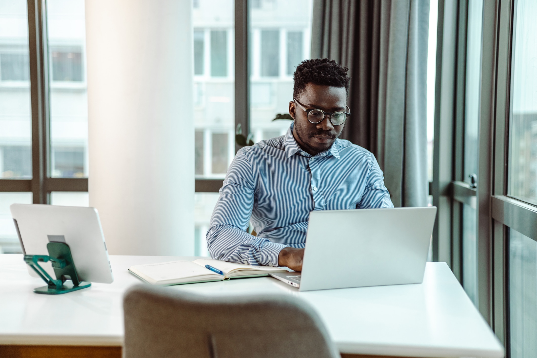 Man sitting at a table looking at his computer