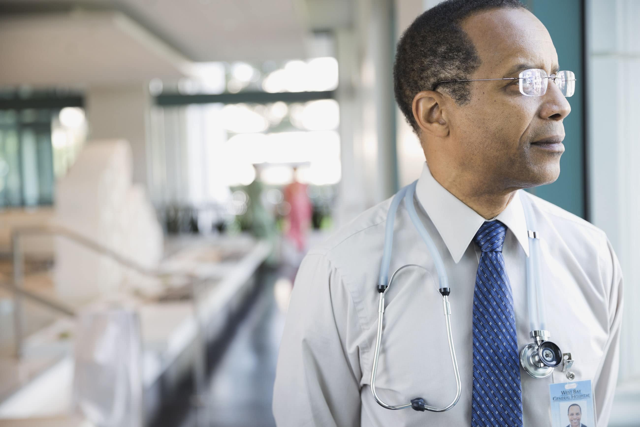 Male doctor looking out of the window