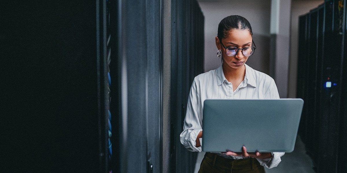 woman holding computer and looking at the screen