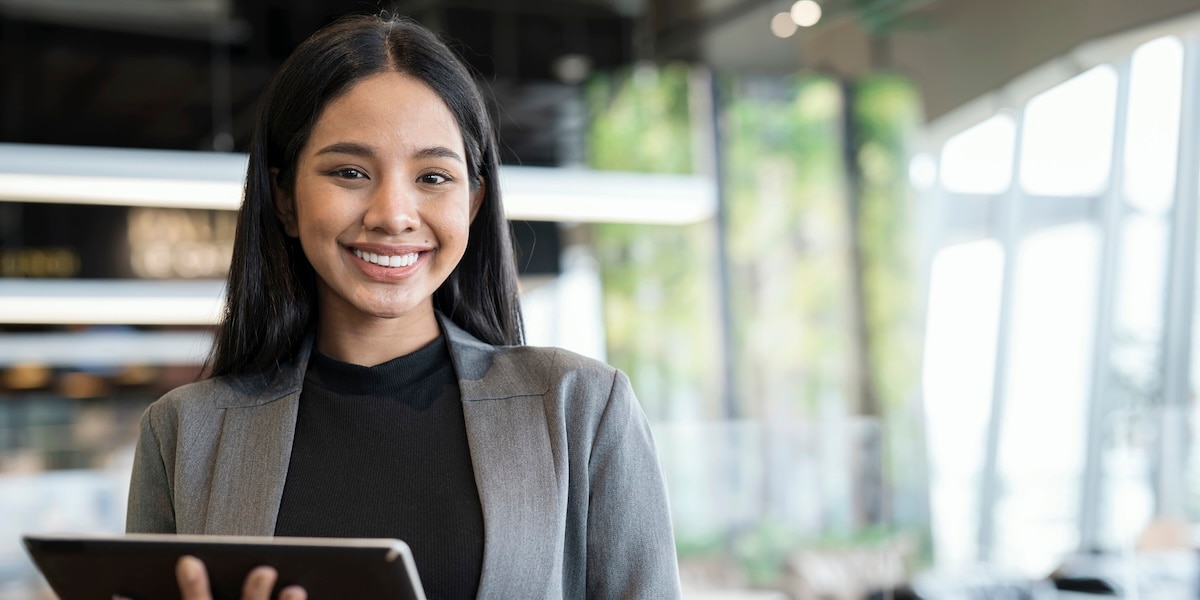 woman holding ipad smiling