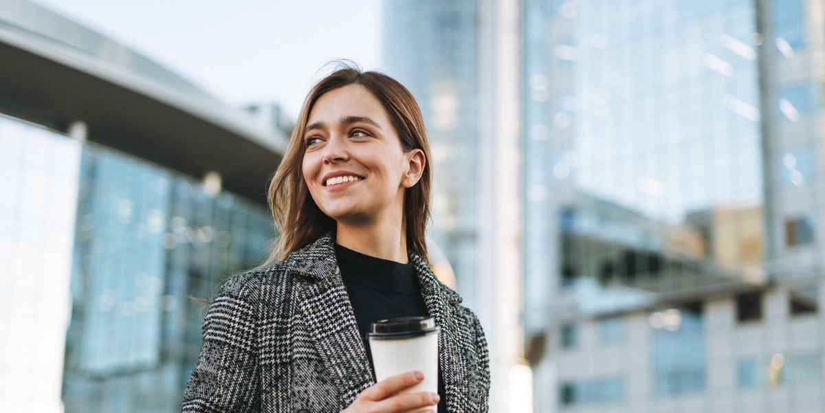 woman holding coffee outside