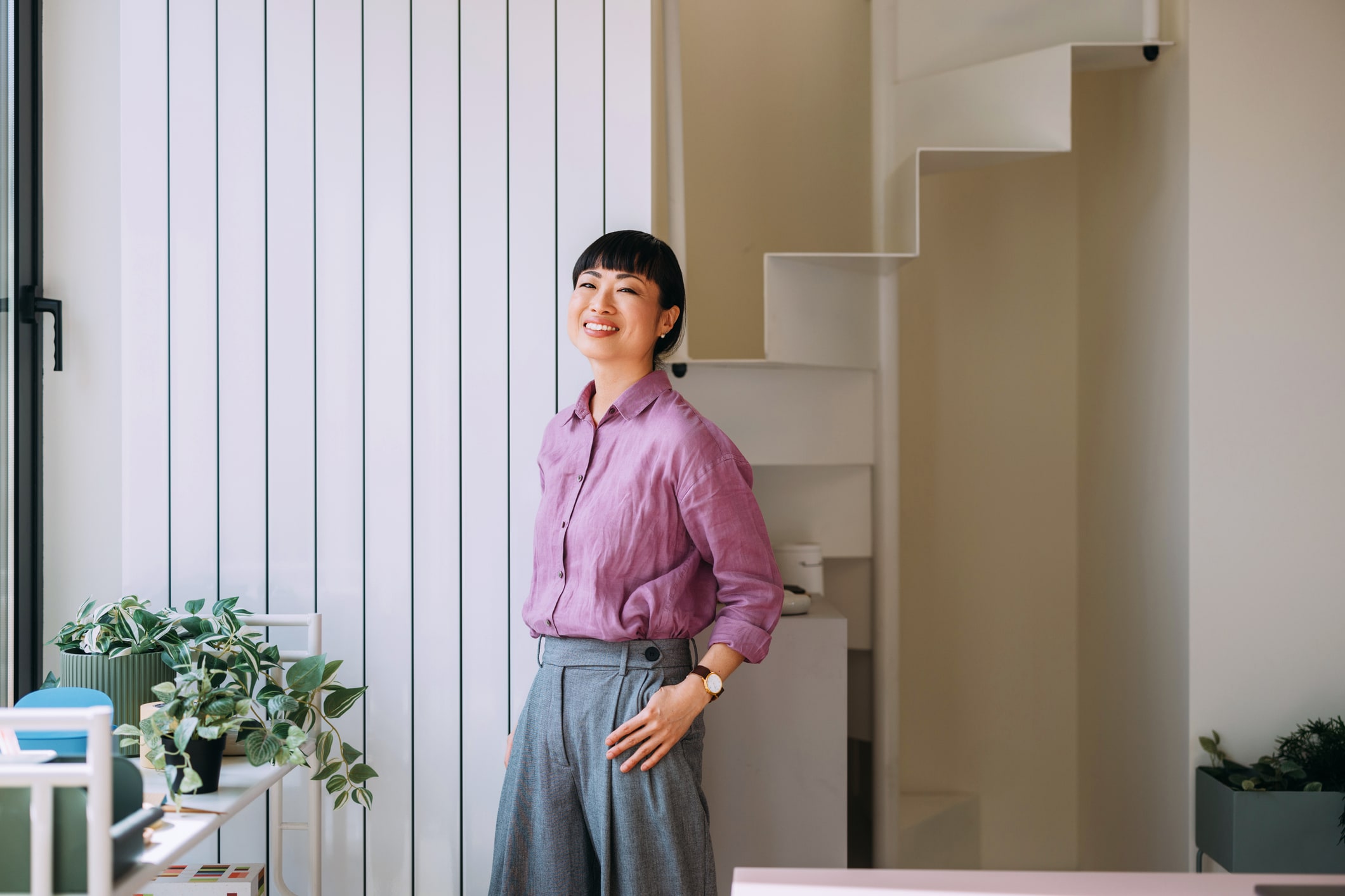 Woman standing in an office smiling