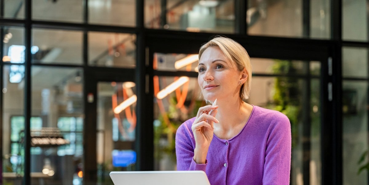 woman in purple shirt at laptop