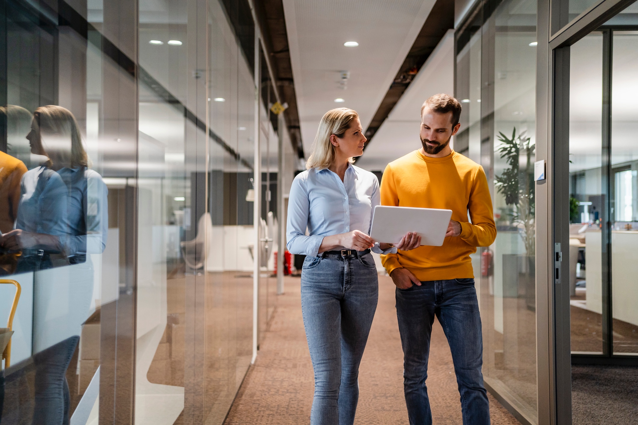 Man and woman looking at their computer in office