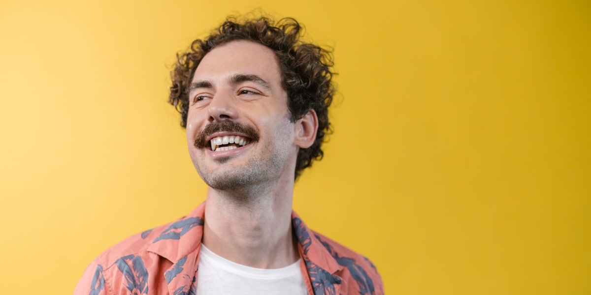 man looking off into distance smiling