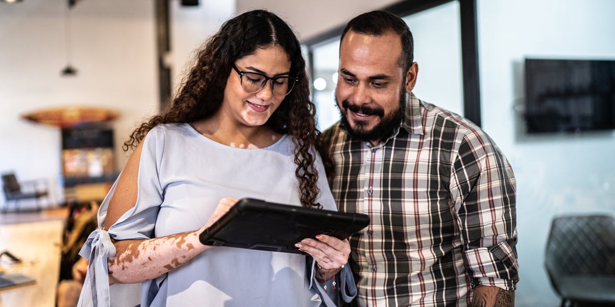Two people looking at tablet