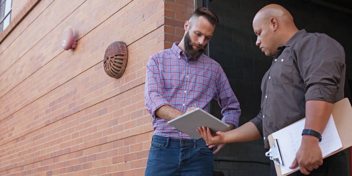 Two men looking at tablet