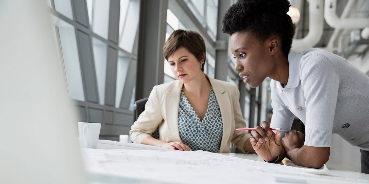 Two business women working collaboratively at a table