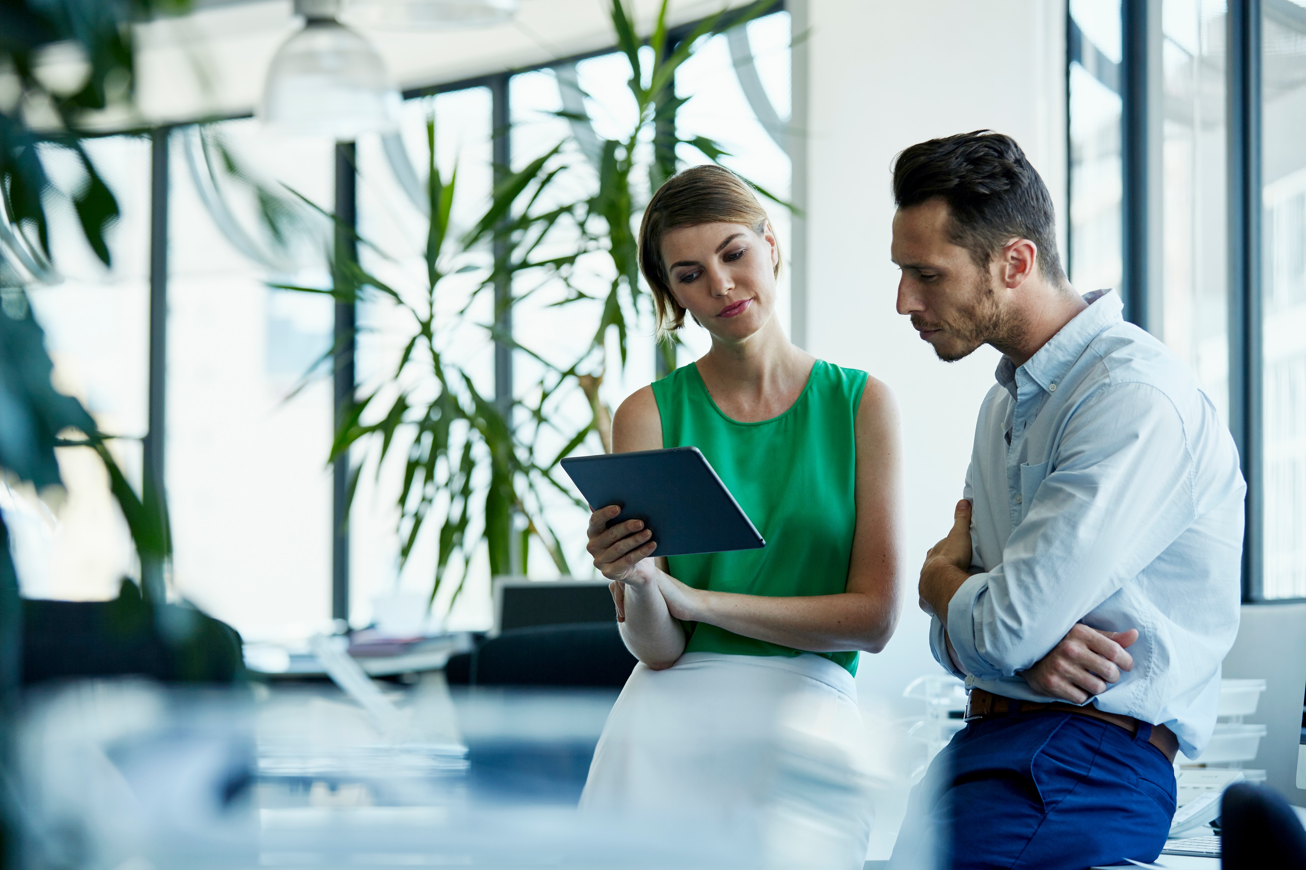 woman and man looking at the screen