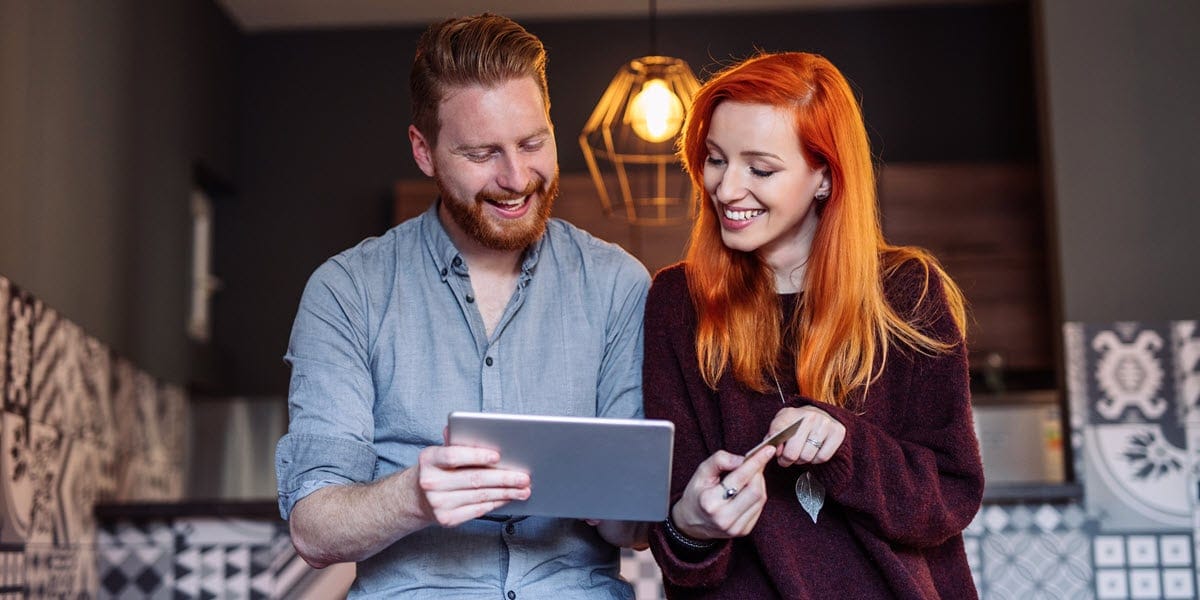 Man and woman looking at tablet