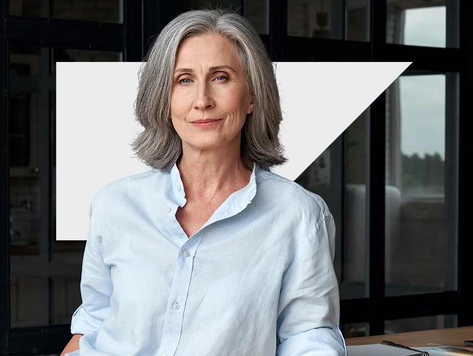 Woman in a business shirt smiling at camera