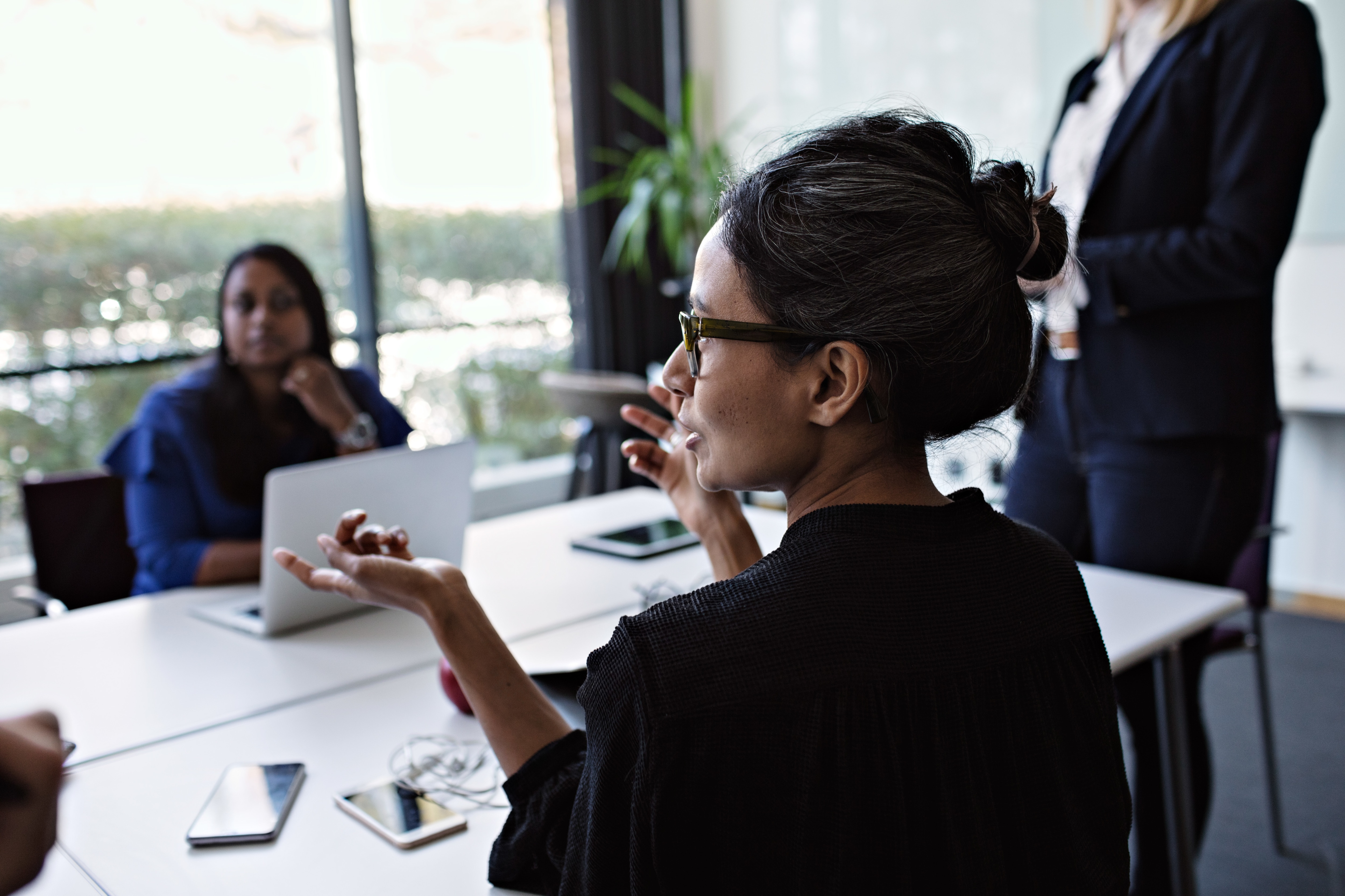 Lady talking at a business meeting about spend control