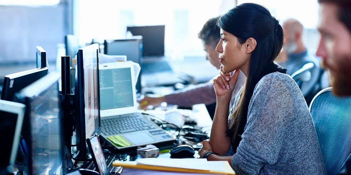Woman in an office looking at a computer screen