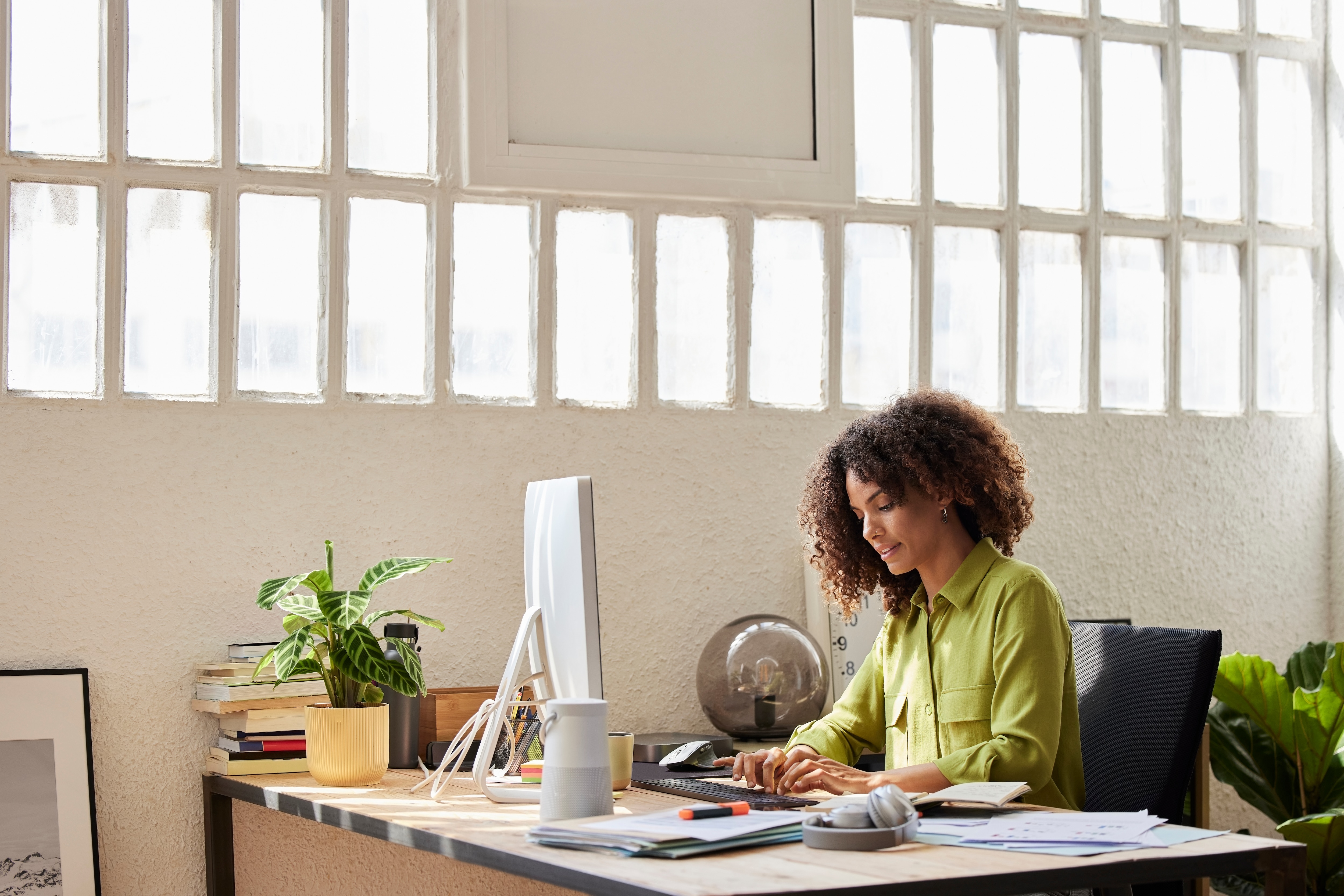 Woman sitting at her desk reading about control and compliance solutions