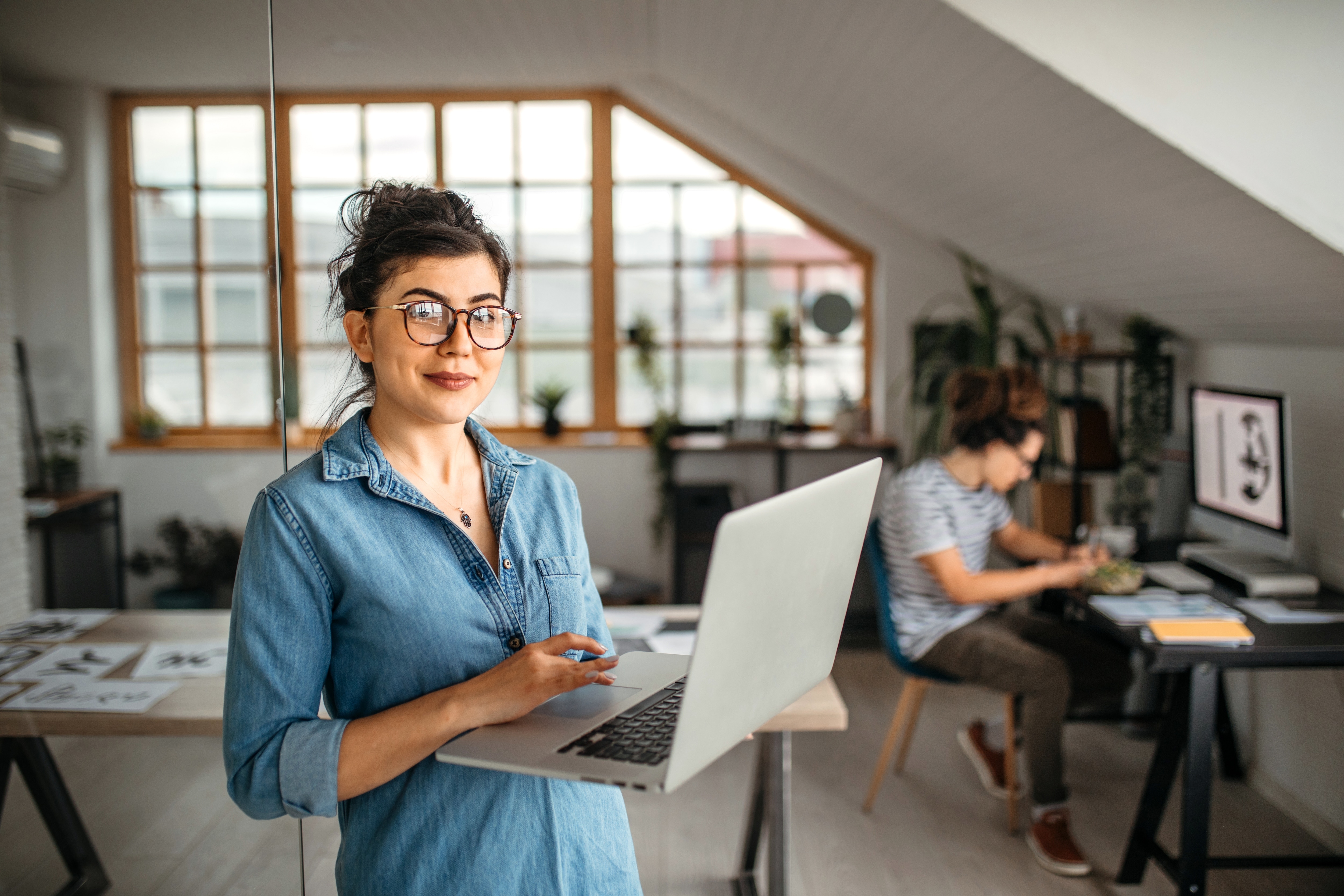 Woman holding a laptop ready for configuration set up