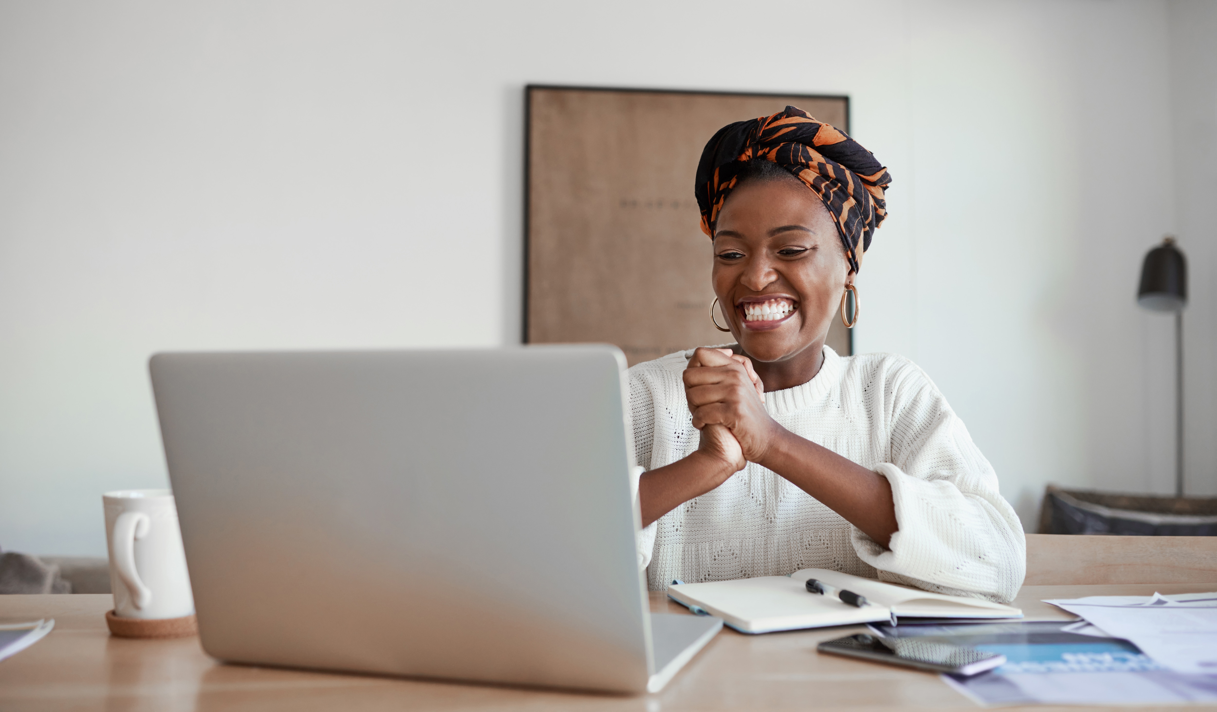 a woman looking at her laptop 