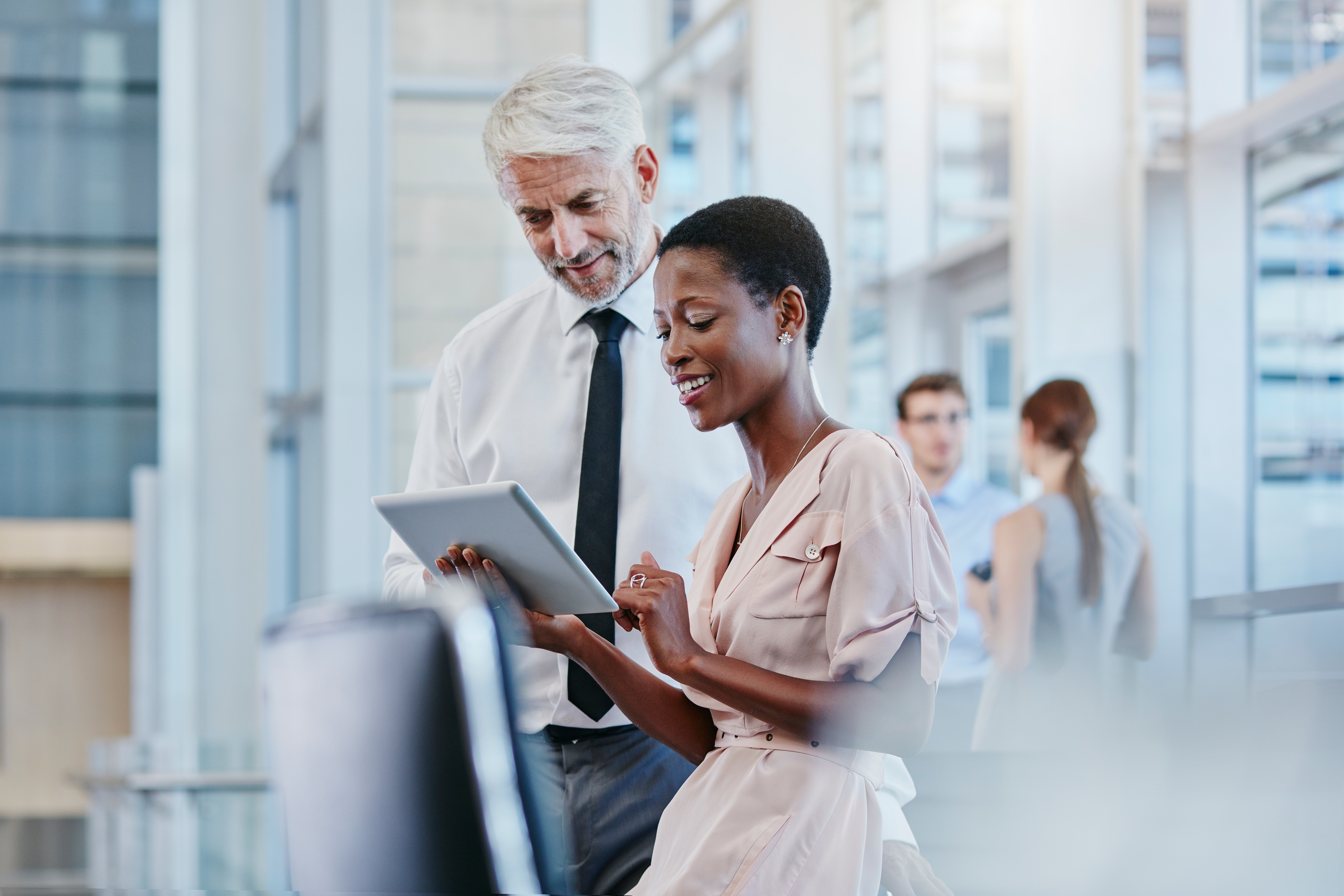 Man and woman looking at a tablet in an office