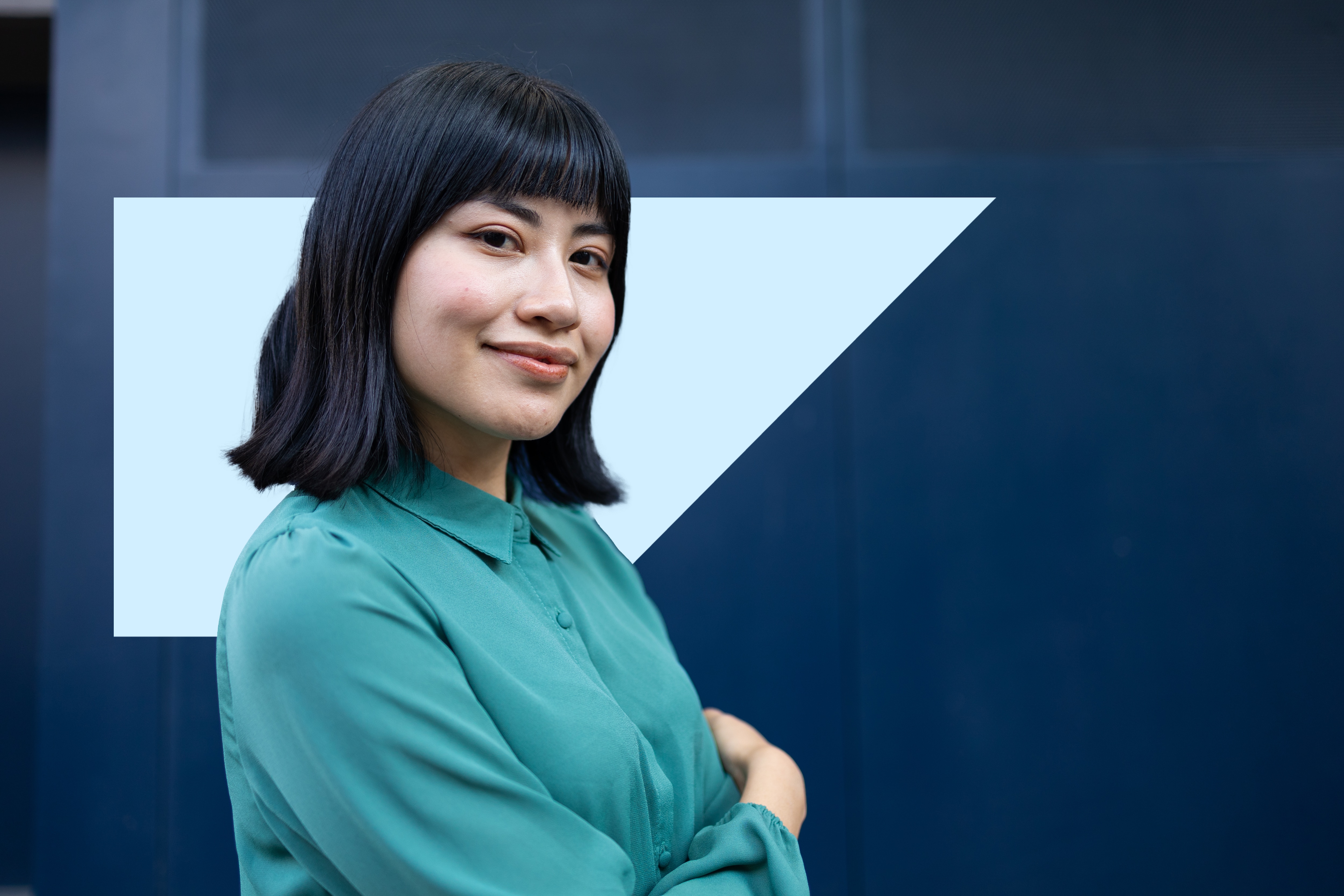 Two people looking at an ipad in front of an office building