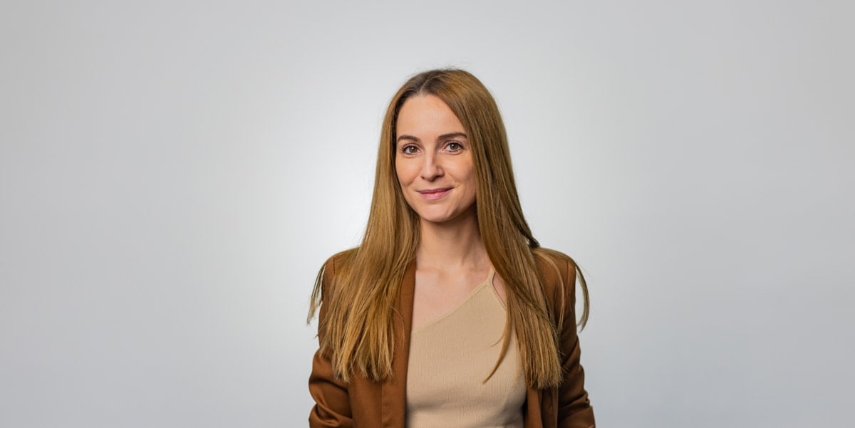 woman in brown blazer 