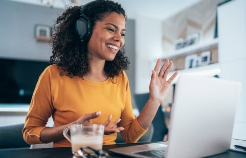 A remote worker on a call using a laptop