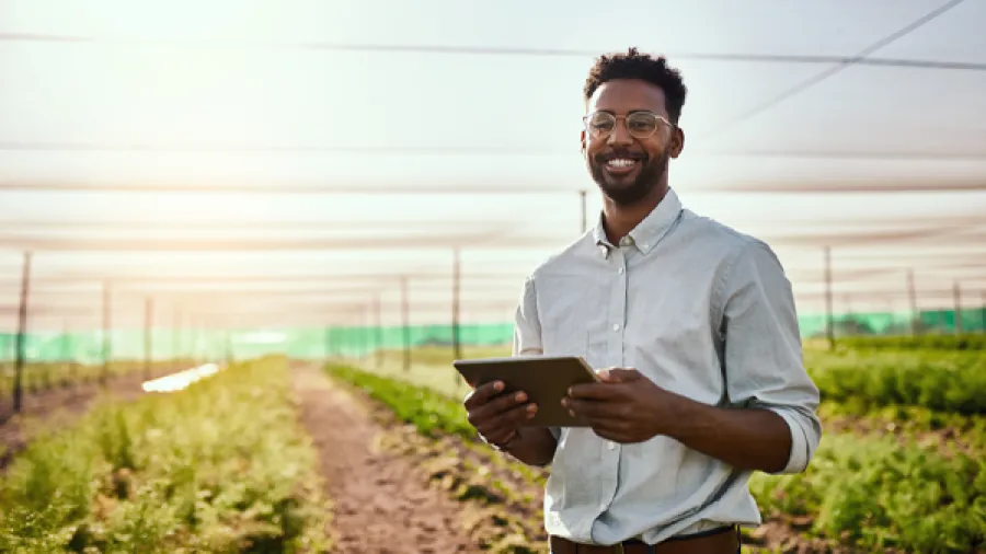 man in the field on ipad