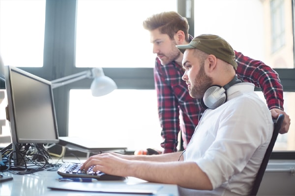 two people working on a computer