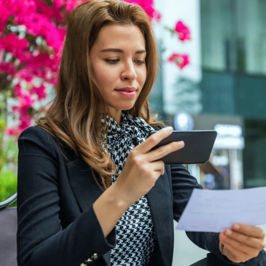 woman taking photo of receipt