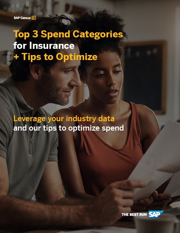 A man and woman review a document together while seated at a table