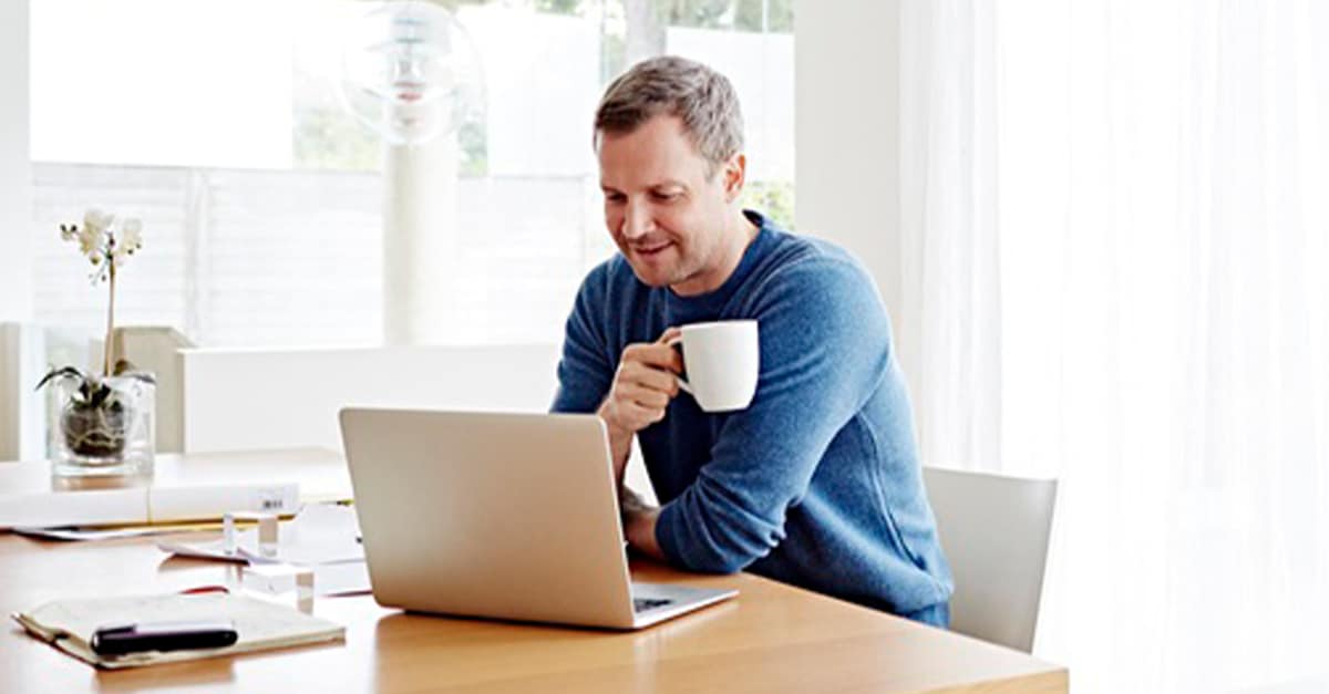 person on laptop with coffee